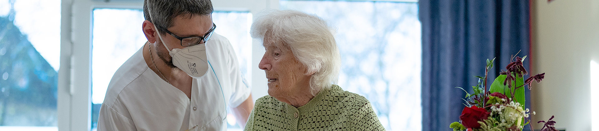 Bild | Pfleger spricht mit Seniorin